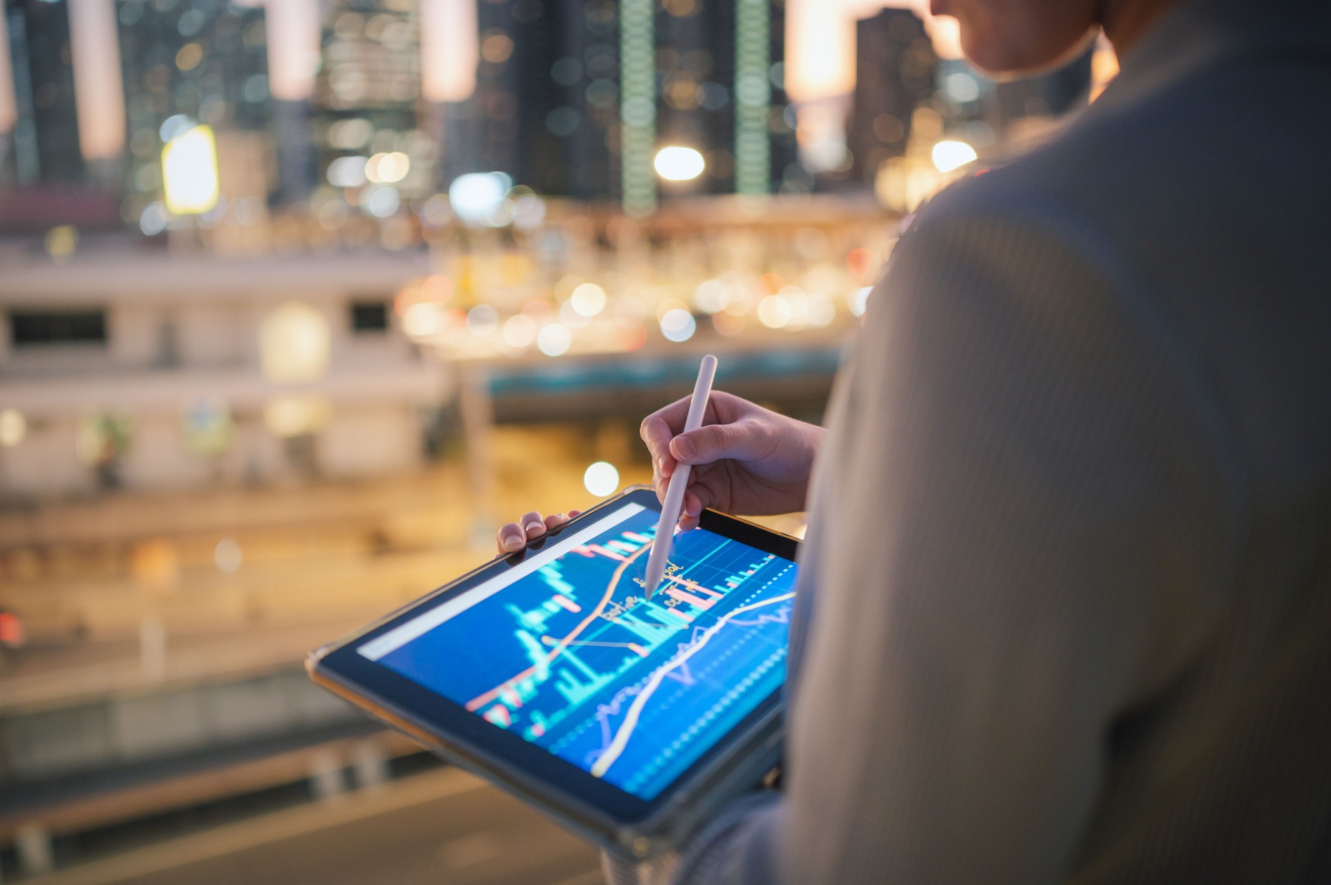 Asian modern Business people consult invet performance tracking form chart and graph on her digital tablet